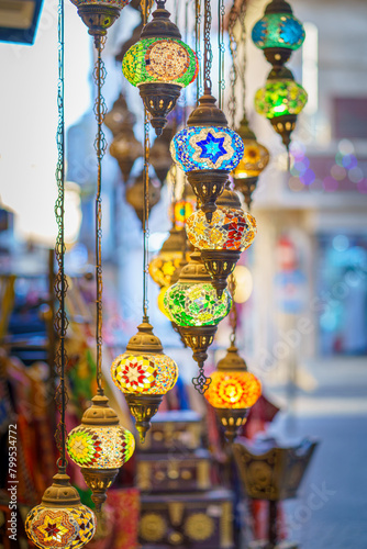 Close-up view of multicolored antique glass lamps and lanterns with patterns, in souvenir shop, at Souq Bab Al Bahrain, the background is blurred, Manama, Bahrain 