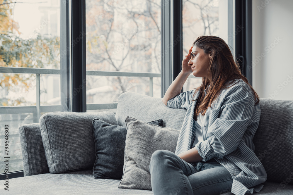 Close up of sad pensive millennial woman sit alone thinking about relationships personal problems, upset thoughtful young female lost in thoughts feel lonely depressed pondering or mourning at home. Close up of sad pensive millennial woman sit alone thinking about relationships personal problems, upset thoughtful young female lost in thoughts feel lonely depressed pondering or mourning at home.