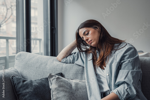Close up of sad pensive millennial woman sit alone thinking about relationships personal problems, upset thoughtful young female lost in thoughts feel lonely depressed pondering or mourning at home.