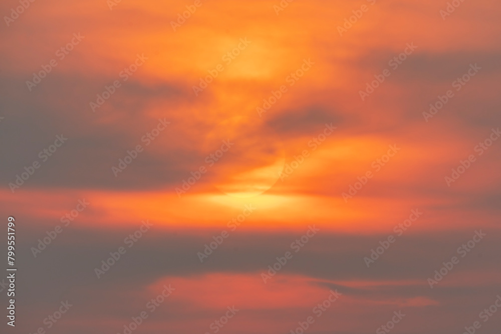 Evening sky time with sun and orange clouds in sunset sky background.Heat wave hot sun, climate change and global warming concept.