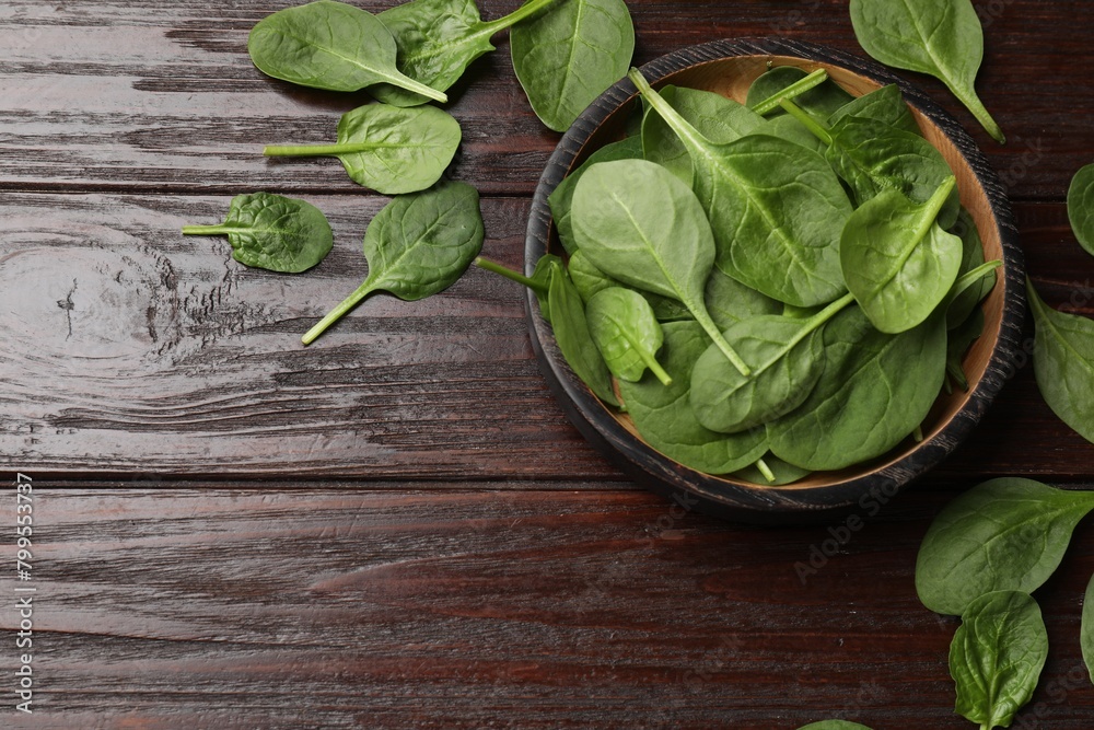 Fresh spinach leaves on wooden table, flat lay. Space for text Fresh spinach leaves on wooden table, flat lay. Space for text