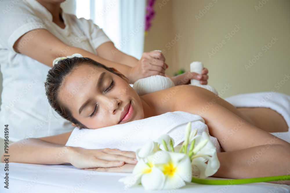 At serene spa setting, Asian young woman enjoys Thai massage, with focus on holistic wellness and tranquility, immersing herself in relaxation At serene spa setting, Asian young woman enjoys Thai massage, with focus on holistic wellness and tranquility, immersing herself in relaxation