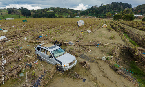 SUV and farm equipment sprawled over a destroyed vineyard from the Cyclone Gabrielle natural disaster. Eskdale, Napier, Hawke's Bay, New Zealand. February 2023