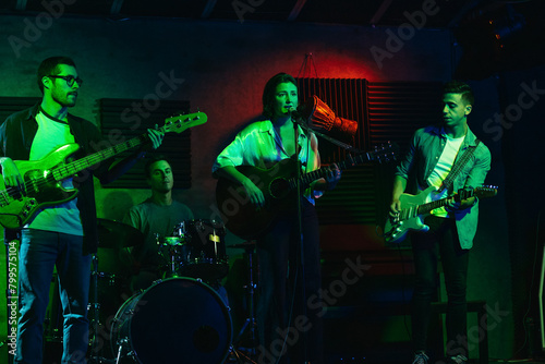 Musicians In Stage With Colorful Lights Performing In A Live Concert © PEDROMERINO