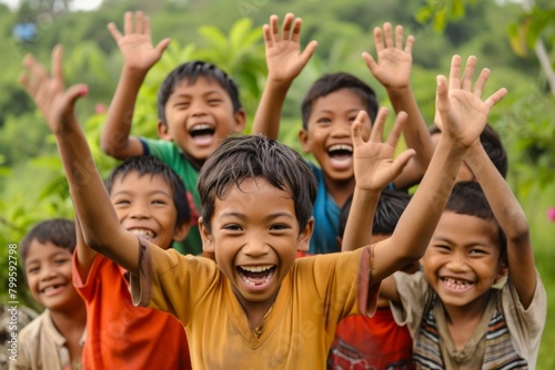 Group of happy children with their hands up in the air and smiling
