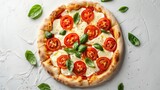 Top shot of a freshly made Caprese pizza, featuring juicy tomatoes and creamy mozzarella on a stark, white background, highlighted by studio lights
