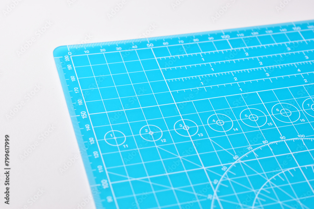 blue cutting mat board on white background with line and scale measure guide pattern for object art design, tool equipment of diy craft work