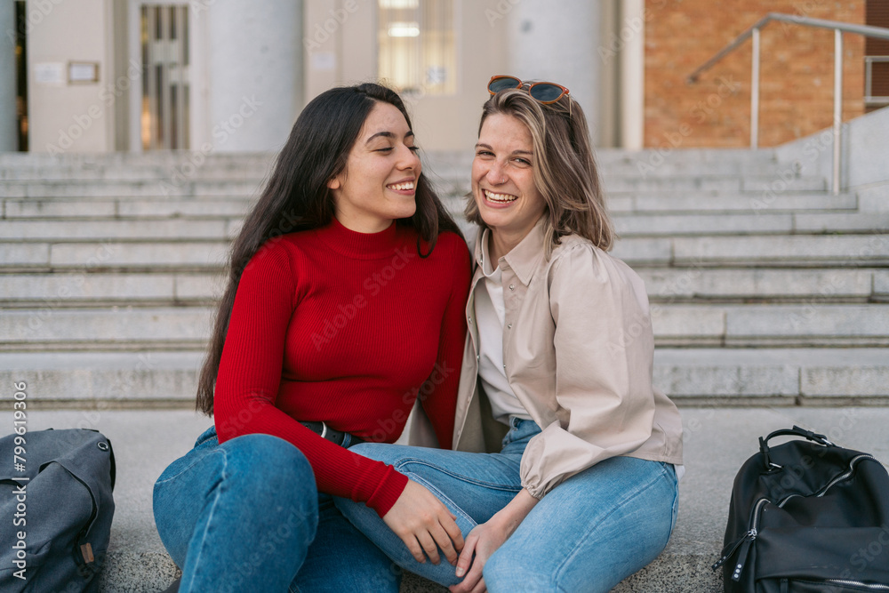 portrait of two student girls sitting on the stairs portrait of two student girls sitting on the stairs