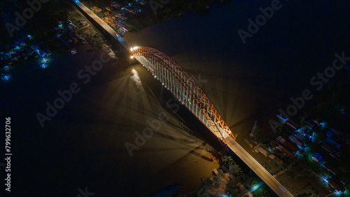 Rumpiang Bridge in the night, a bridge that stretches over the Barito river, Marabahan city, Barito Kuala district, South Kalimantan photo