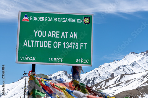 Green sign marking the summit of a high mountain pass in the northern Indian Himalayas near Leh photo