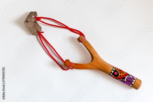 Handmade wooden slingshot on a white background. Wooden toy.