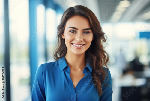 Smiling young professional woman in blue shirt