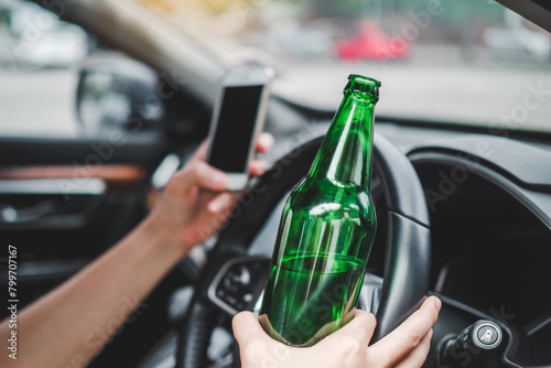 Obraz na plátně Drunk man driving a car on the road holding bottle beer Dangerous drunk driving