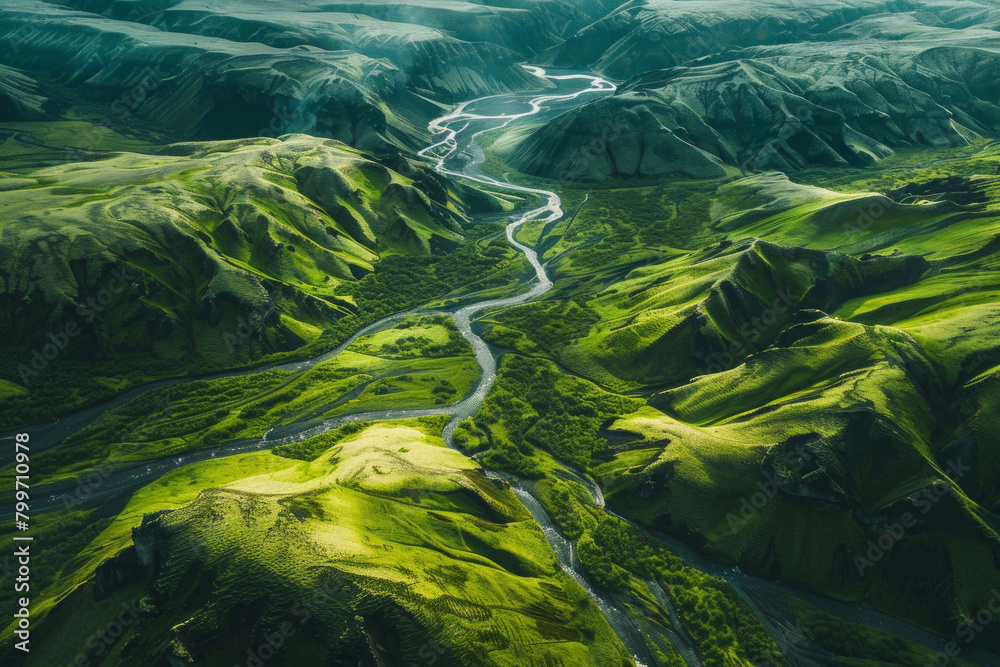Aerial view of vivid green landscapes with a blur river flowing through the valley