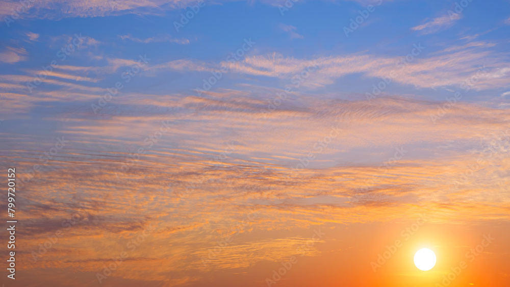 Sunrise sky with many orange clouds and yellow sunlight on horizon sky background in the morning, Beautiful idyllic natural tranquil scene