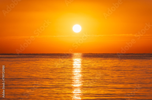 Beautiful red and orange sunrise over the sea. © Dmitrii Potashkin