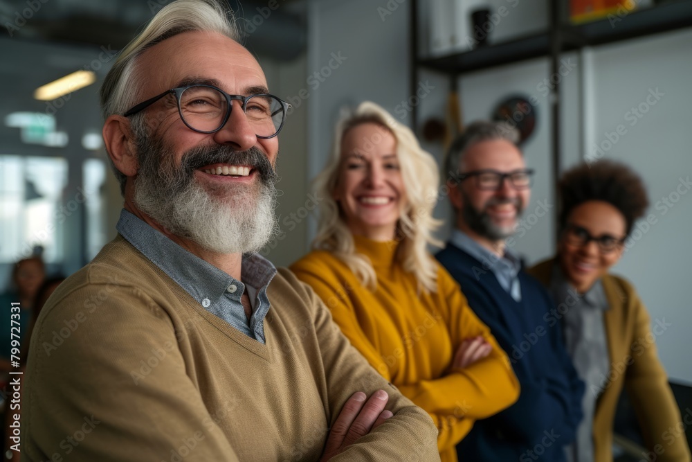 Portrait of a smiling senior businessman with his team in the background Portrait of a smiling senior businessman with his team in the background