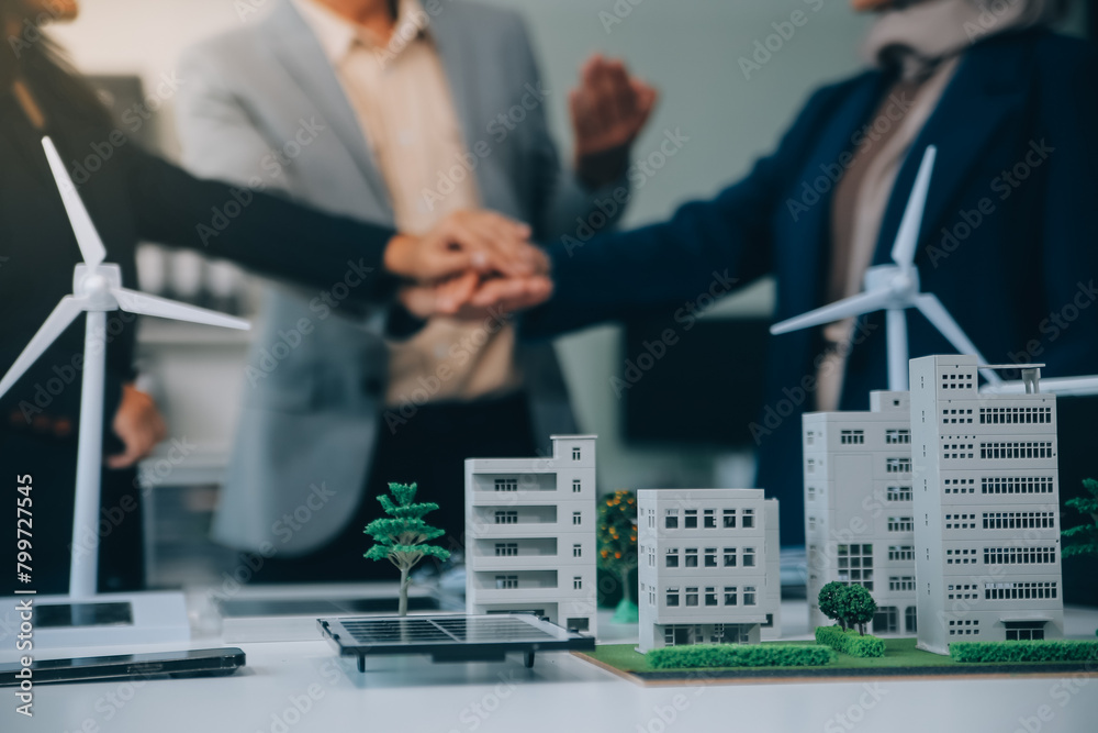 Fototapeta premium Two business executives, elegantly attired in suits, join hands in a gesture of unity, solidarity, and shared commitment towards a common goal or venture.
