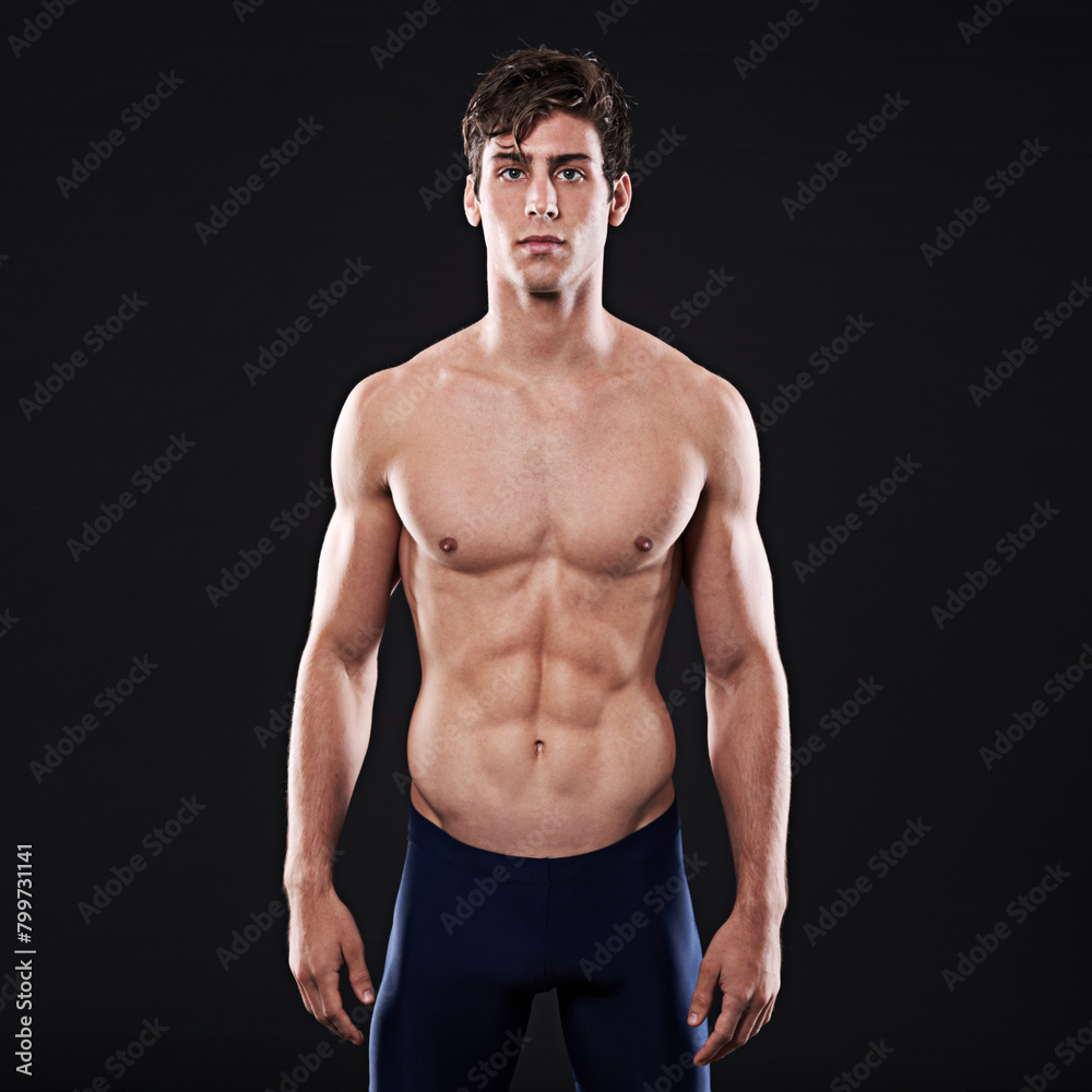 Fototapeta premium Man, studio and body portrait or confident athlete, workout and swimming training for health exercise. Wellness instructor, serious and male person in swimwear and isolated on black background