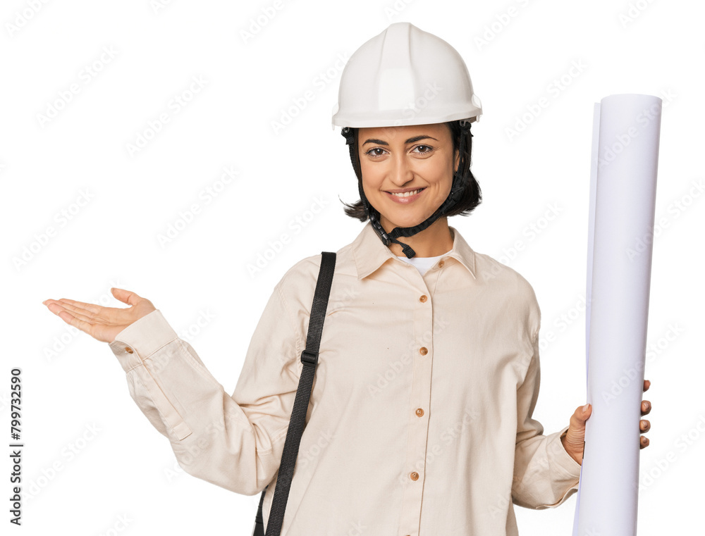 Young Caucasian female architect in studio showing a copy space on a palm and holding another hand on waist. Young Caucasian female architect in studio showing a copy space on a palm and holding another hand on waist.