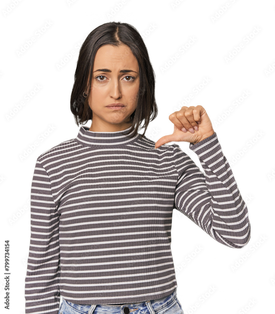 Young Caucasian woman with short hair showing a dislike gesture, thumbs down. Disagreement concept. Young Caucasian woman with short hair showing a dislike gesture, thumbs down. Disagreement concept.