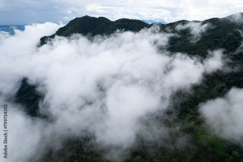 Landscape of Morning Mist with Mountain Layer at north of Thailand. mountain ridge and clouds in rural jungle bush forest