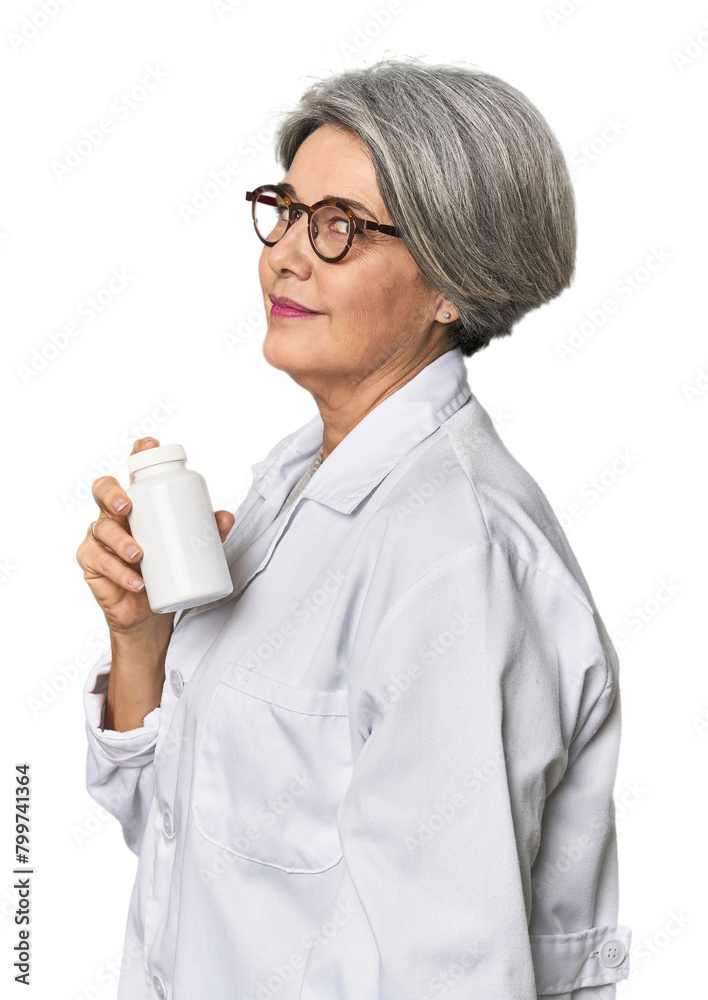 Caucasian mid-age pharmacist with pill bottle looks aside smiling, cheerful and pleasant. Caucasian mid-age pharmacist with pill bottle looks aside smiling, cheerful and pleasant.
