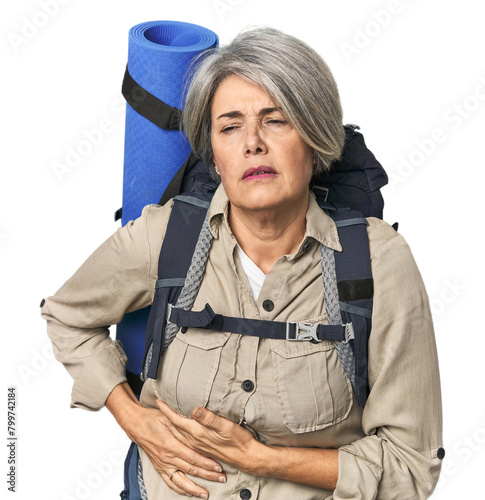 Caucasian mid-age female with hiking gear having a liver pain, stomach ache.