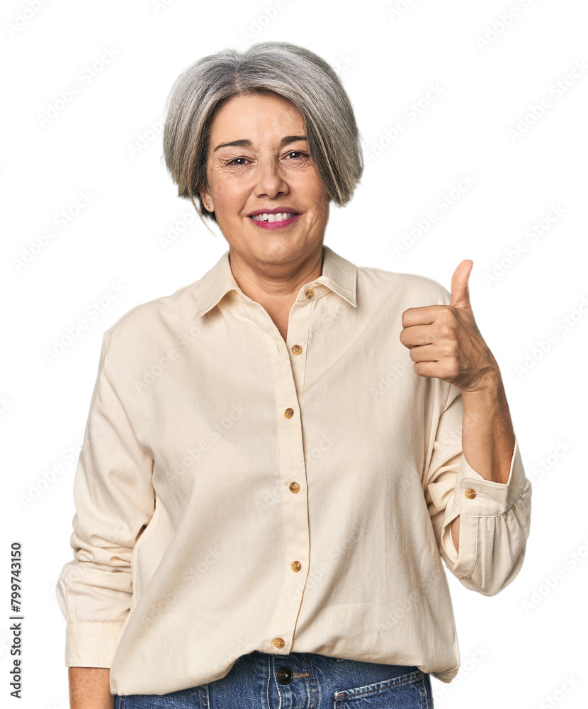 Caucasian mid-age female on studio background smiling and raising thumb up Caucasian mid-age female on studio background smiling and raising thumb up