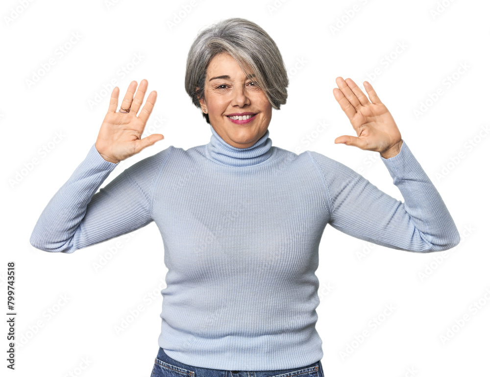 Caucasian mid-age female on studio background showing number ten with hands. Caucasian mid-age female on studio background showing number ten with hands.