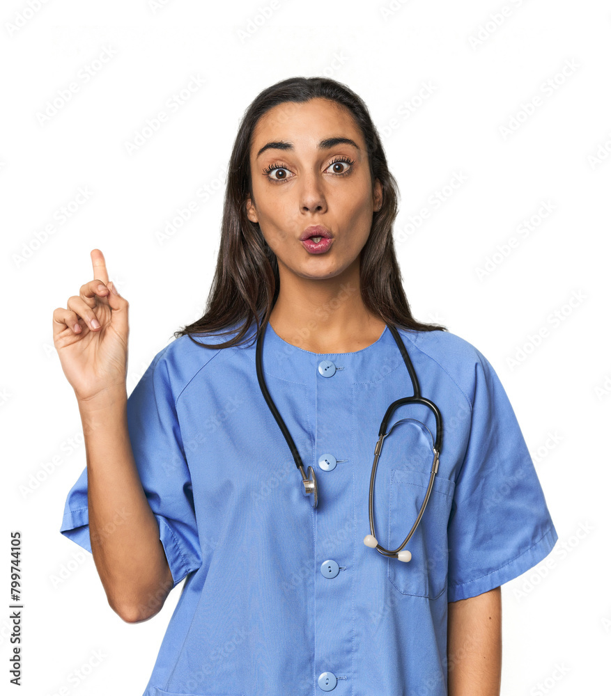 Hispanic nurse in uniform with stethoscope having some great idea, concept of creativity. Hispanic nurse in uniform with stethoscope having some great idea, concept of creativity.