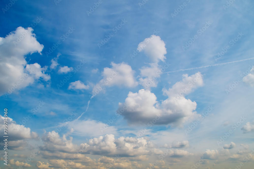 Summer sky with low white clouds. Blue sky with clouds receding into perspective. Summer sky with low white clouds. Blue sky with clouds receding into perspective.