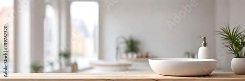 Wooden table top and defocused bathroom sink counter as background