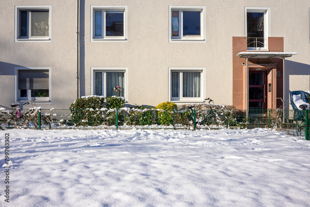 Winter's Touch on a Suburban Home, Snow-Covered Garden in a Quiet german Neighborhood.