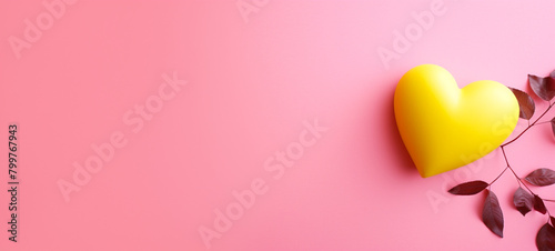 A yellow heart-shaped object is hanging on a pink wall, generative AI