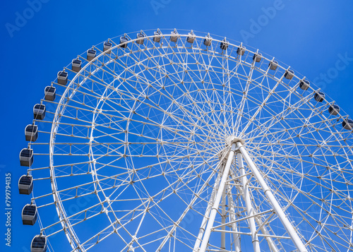 white big ferris wheel on background a clear blue sky in Navruz Park in Tashkent in summer close up