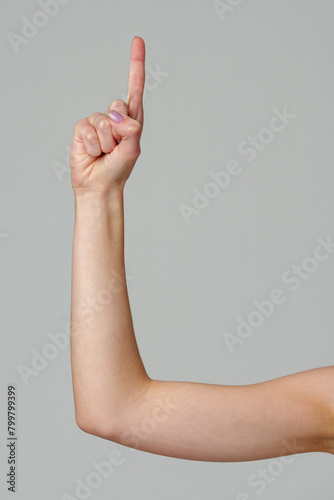 Female hand gesturing numbers on gray background