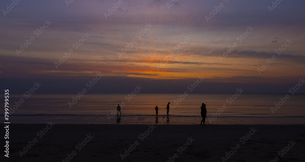 Silhouettes Beach Evening Glow with People Activity and Walking by the Sea