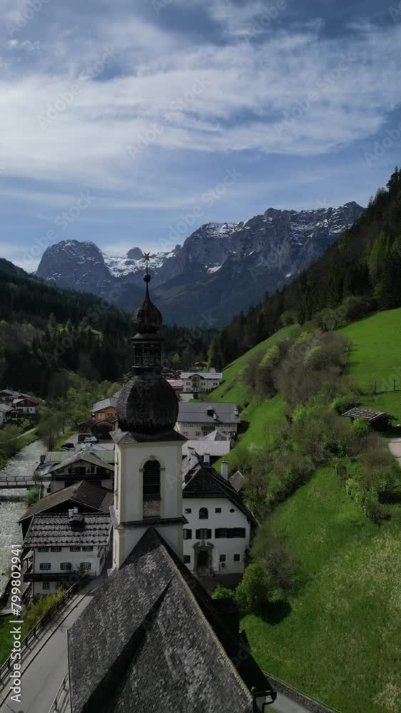 Bavarian Ramsau Berchtesgaden view along a church and icy cold mountain river with the Watzmann mountain chain at the background Bavarian Ramsau Berchtesgaden view along a church and icy cold mountain river with the Watzmann mountain chain at the background