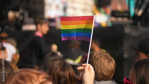 Many people wave small rainbow flag. Fun lgbt community symbol. Stop no homophobia concept. Joy pride month fest. Bi gay men crowd go csd love day. Queer culture parade. Hold little colorful flag. photo