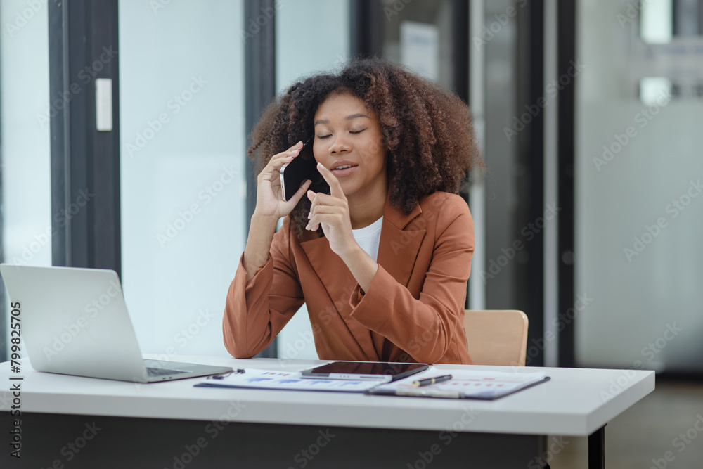 African American businesswoman excited by the good news on the phone. African American businesswoman excited by the good news on the phone.