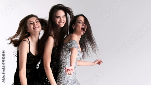 Group of fashionable women posing in the studio. Diverse women having fun and posing against a light background. Concept of fashion  style and youth.