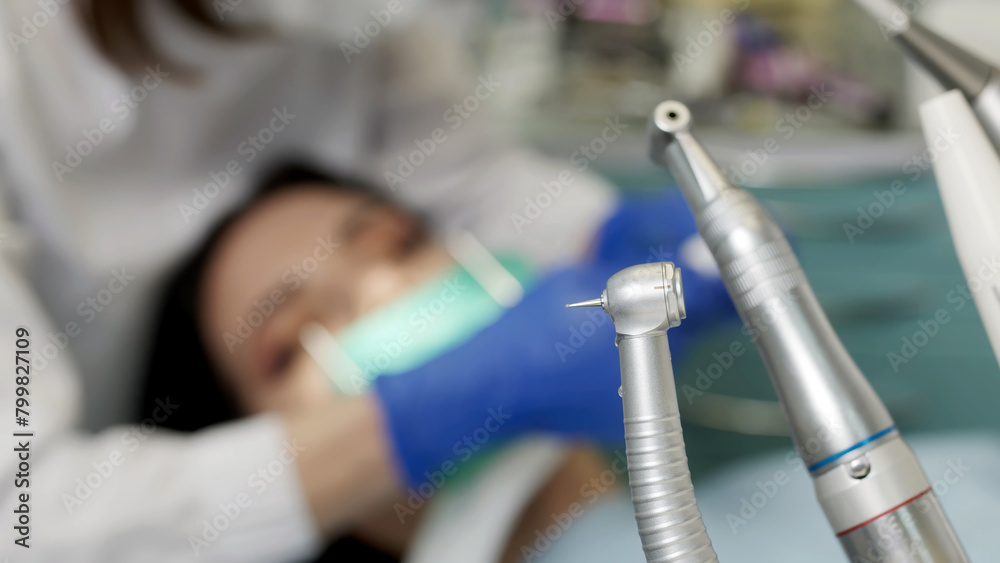 Young female dentist during work process, close-up of young woman's dental treatment. Concept of healthy teeth and modern treatment in a dental clinic.