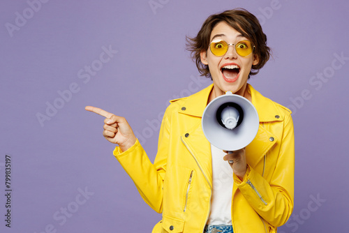 Young excited woman wears yellow shirt white t-shirt casual clothes glasses hold megaphone scream announces discounts sale Hurry up isolated on plain pastel light purple background. Lifestyle concept.