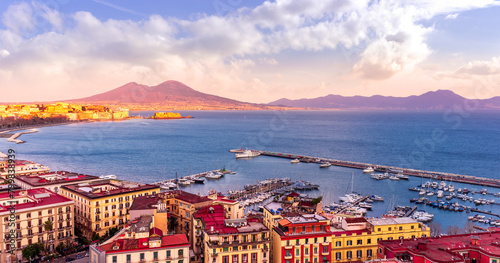 beautiful panorama of Naples city with amazing coast, sea port, streets and buildings and volcano Vesuvius with anazing sky on background photo