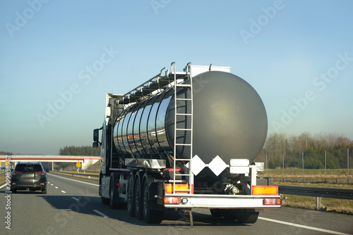 Automotive fuel tankers shipping fuel. Isothermal Tank truck driving on a highway.