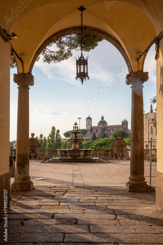 Italy, Lazio, Viterbo, Fontana di Palazzo dei Priori with arch in foreground photo