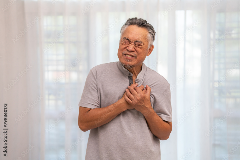 Senior asian adult elderly man with chest pain suffering from heart attack, health and medical, heart health, heart attack, world heart day, cardiovascular disease.insurance and hospital concept