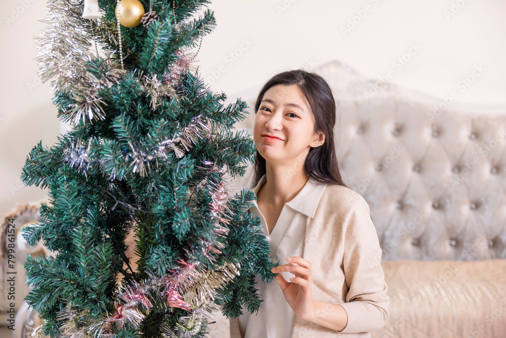 woman decorating christmas tree woman decorating christmas tree