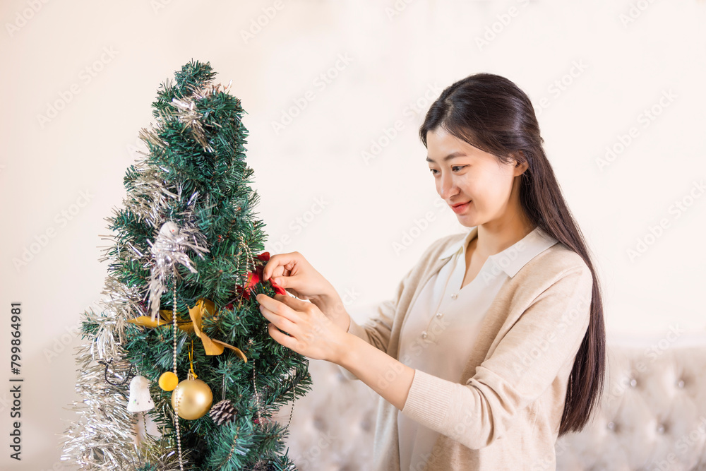 woman decorating christmas tree woman decorating christmas tree